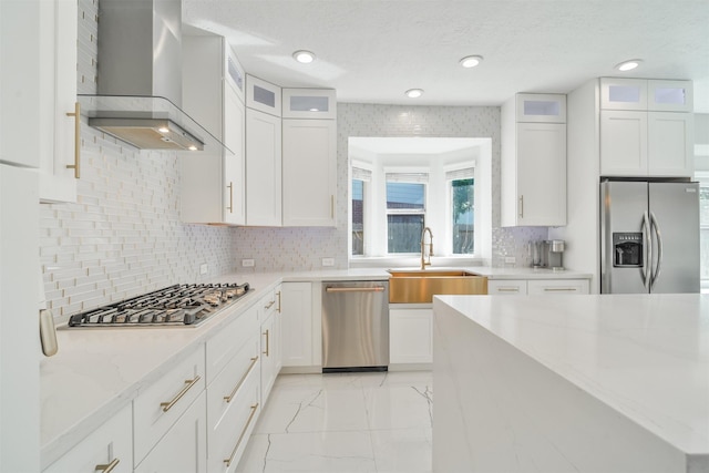 5515 E Terrace Gable Cir, Katy, TX 77494 - kitchen with appliances with stainless steel finishes, a sink, wall chimney exhaust hood, light marble finish flooring, and light stone countertops