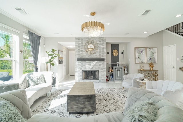 5515 E Terrace Gable Cir, Katy, TX 77494 - living room with a chandelier, crown molding, a tiled fireplace, baseboards, and stairway