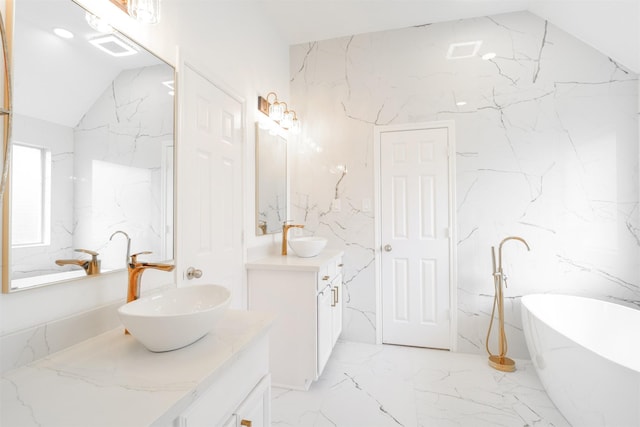 5515 E Terrace Gable Cir, Katy, TX 77494 - bathroom featuring marble tiled flooring, vanity, lofted ceiling, and stone wall