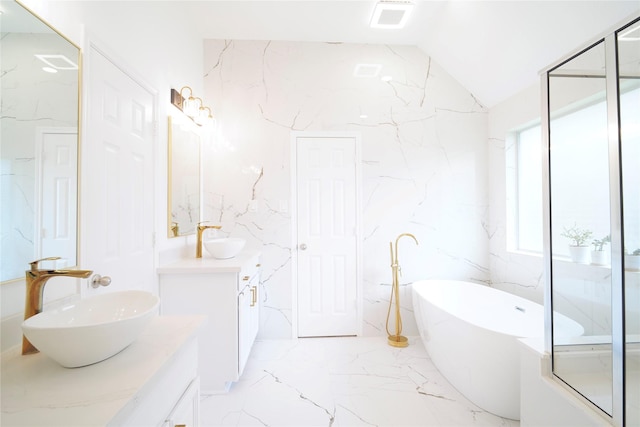 5515 E Terrace Gable Cir, Katy, TX 77494 - bathroom featuring two vanities, marble tiled flooring, a freestanding bath, and vaulted ceiling