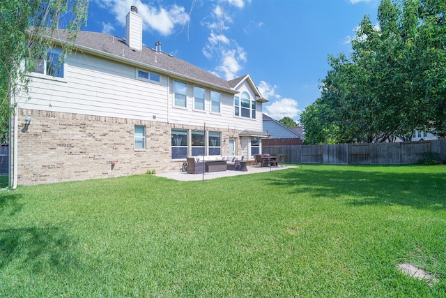 5515 E Terrace Gable Cir, Katy, TX 77494 - rear view of property featuring an outdoor hangout area, a patio, brick siding, and a chimney