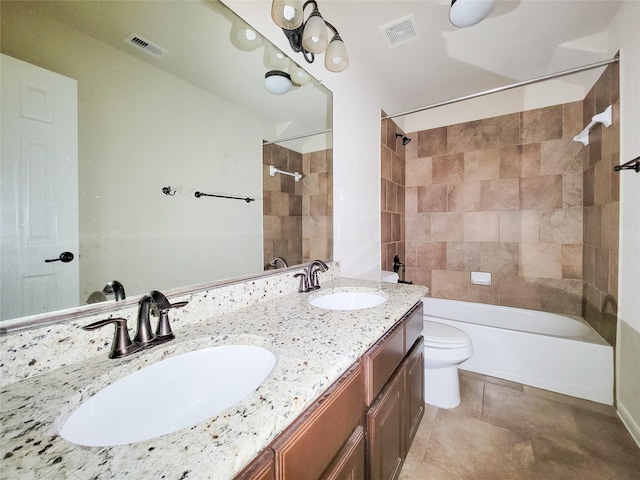 bathroom with toilet, shower / bathtub combination, double vanity, and tile patterned floors