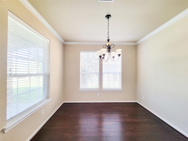 unfurnished room with a chandelier, dark wood-style floors, crown molding, and baseboards