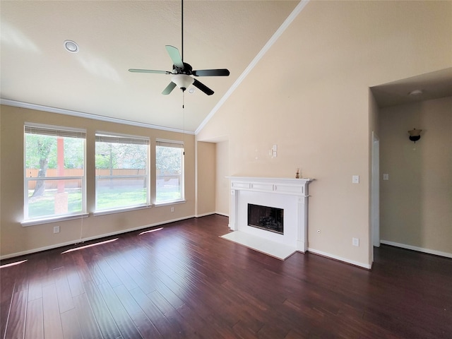 unfurnished living room with lofted ceiling, a ceiling fan, ornamental molding, a fireplace with flush hearth, and dark wood finished floors