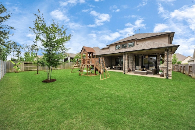 17355 Camillia Trl, Conroe, TX 77302 - back of house featuring an outdoor hangout area, a playground, a patio area, and a shingled roof