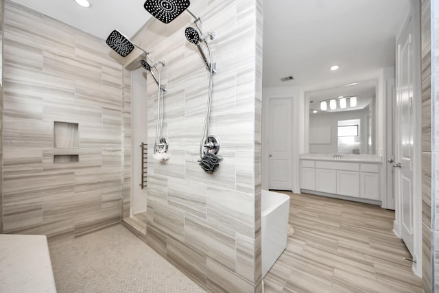17355 Camillia Trl, Conroe, TX 77302 - bathroom featuring walk in shower, vanity, recessed lighting, and a soaking tub