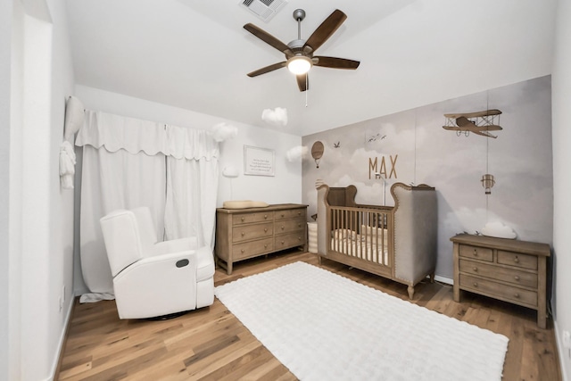 17355 Camillia Trl, Conroe, TX 77302 - bedroom with a nursery area, wood finished floors, and a ceiling fan