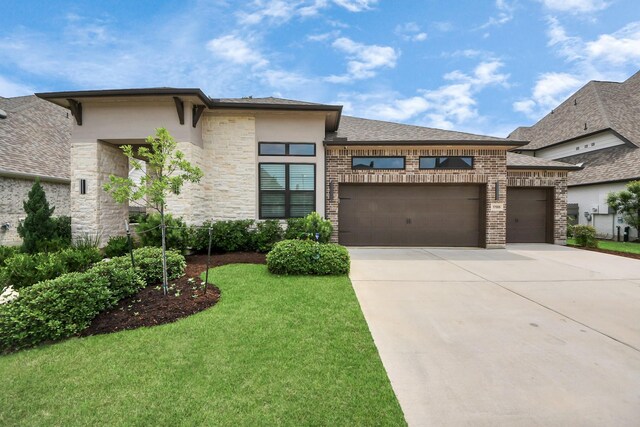 17355 Camillia Trl, Conroe, TX 77302 - view of front of property with a garage, driveway, a front yard, stucco siding, and stone siding