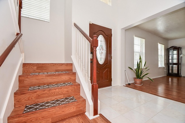 16023 Mission Glen Dr, Houston, TX 77083 - foyer with stairway, light wood-style flooring, and baseboards