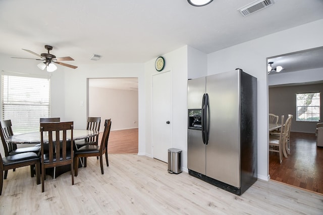 16023 Mission Glen Dr, Houston, TX 77083 - dining area with light wood finished floors, a ceiling fan, and baseboards