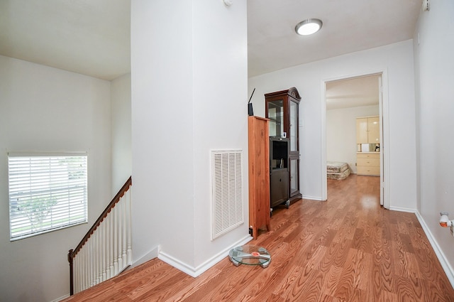16023 Mission Glen Dr, Houston, TX 77083 - corridor with an upstairs landing, wood finished floors, and baseboards