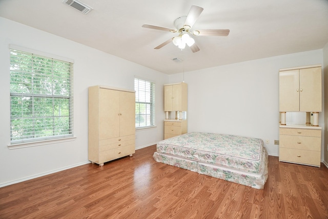 16023 Mission Glen Dr, Houston, TX 77083 - bedroom with light wood finished floors, baseboards, and a ceiling fan