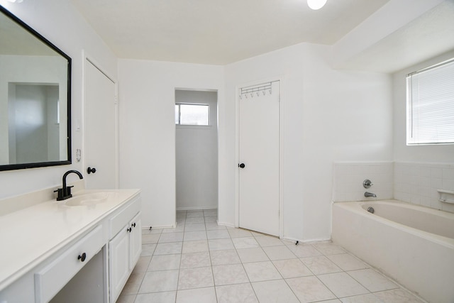 16023 Mission Glen Dr, Houston, TX 77083 - bathroom with vanity, a bath, tile patterned flooring, and baseboards
