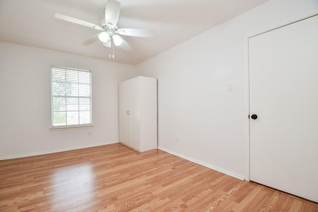 16023 Mission Glen Dr, Houston, TX 77083 - unfurnished bedroom with light wood-style flooring, a ceiling fan, and baseboards