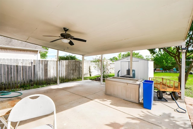 16023 Mission Glen Dr, Houston, TX 77083 - view of patio with a shed, a ceiling fan, fence, and an outbuilding