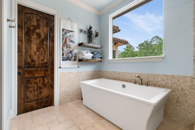 50 Silver Iris Way, The Woodlands, TX 77382 - bathroom with tile walls, a freestanding bath, a wainscoted wall, and crown molding