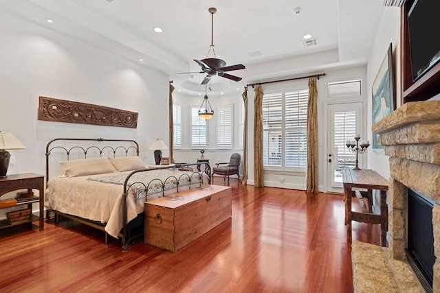 2602 Britton Ridge Dr, Katy, TX 77494 - bedroom featuring a stone fireplace, wood finished floors, recessed lighting, and ceiling fan