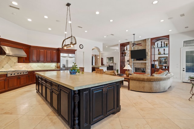 2602 Britton Ridge Dr, Katy, TX 77494 - kitchen featuring wall chimney range hood, stainless steel appliances, a ceiling fan, light tile patterned floors, and recessed lighting