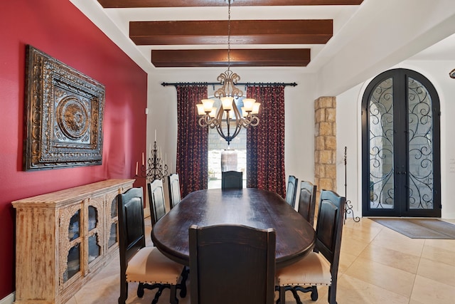2602 Britton Ridge Dr, Katy, TX 77494 - dining area with a chandelier, beam ceiling, french doors, arched walkways, and light tile patterned floors