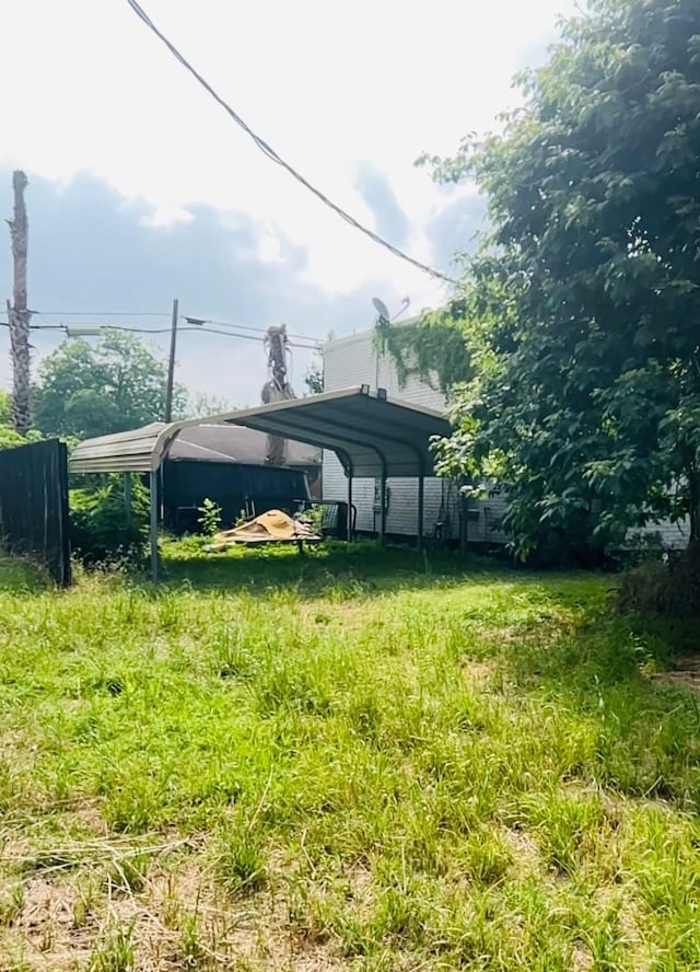 702 Farquhar St, Navasota, TX 77868 - view of yard featuring a detached carport and fence
