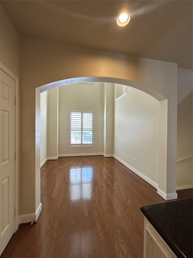 2333 Ann St, Houston, TX 77003 - unfurnished room featuring arched walkways, dark wood-style floors, baseboards, and recessed lighting