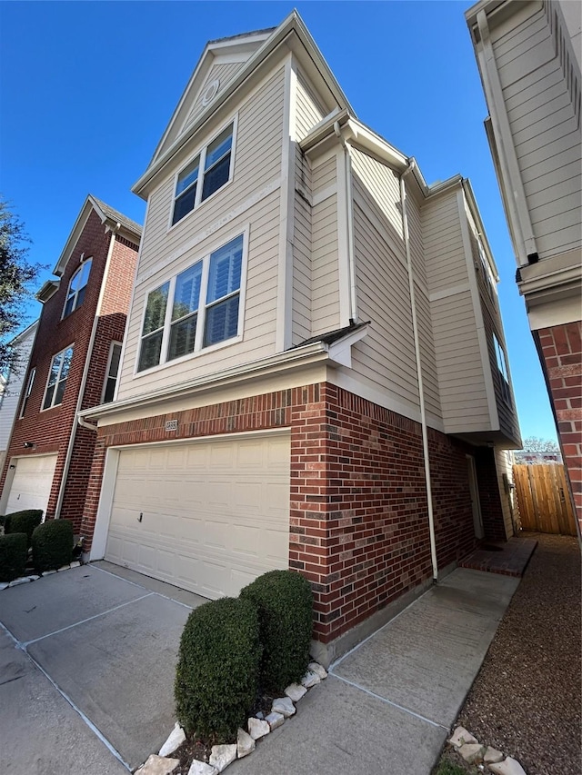 2333 Ann St, Houston, TX 77003 - view of property exterior with a garage, fence, brick siding, and driveway