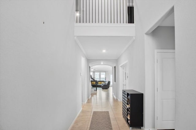 1915 Hays Ranch Dr, Richmond, TX 77469 - corridor with arched walkways, light tile patterned floors, baseboards, crown molding, and recessed lighting