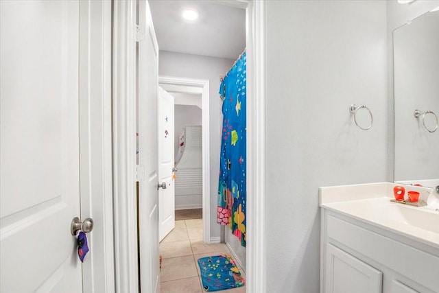 1915 Hays Ranch Dr, Richmond, TX 77469 - full bathroom with tile patterned flooring, vanity, a shower with shower curtain, and baseboards