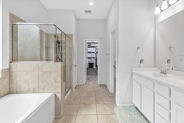 1915 Hays Ranch Dr, Richmond, TX 77469 - full bath featuring a stall shower, a spacious closet, a bath, vanity, and tile patterned floors