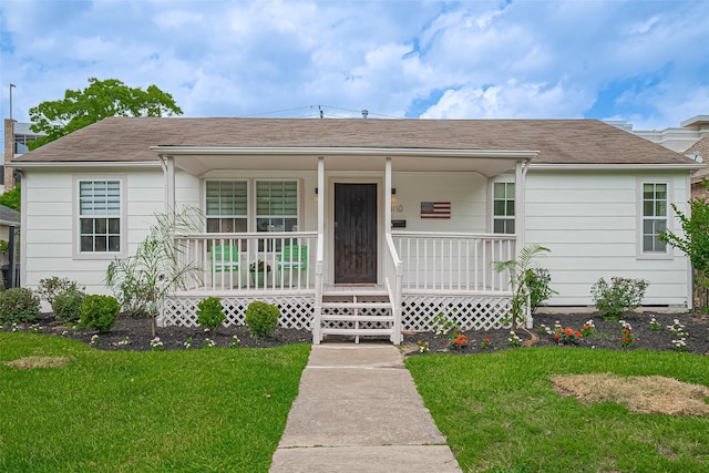 4110 Gramercy St, Houston, TX 77025 - ranch-style house featuring covered porch, a front yard, and roof with shingles
