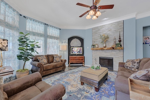 1704 Spring Gln, Pearland, TX 77581 - living room featuring a ceiling fan, wood finished floors, a fireplace, crown molding, and baseboards