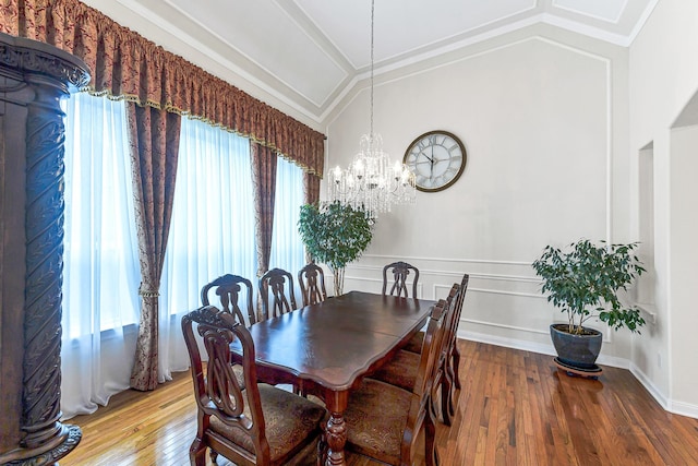 2003 Highland Meadows Dr, Pearland, TX 77089 - dining space featuring vaulted ceiling, a chandelier, hardwood / wood-style flooring, and crown molding