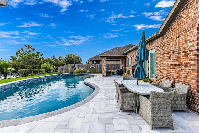2003 Highland Meadows Dr, Pearland, TX 77089 - view of swimming pool featuring a fenced backyard, a patio area, and outdoor dining space