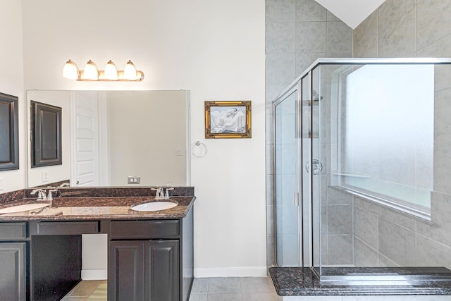 2003 Highland Meadows Dr, Pearland, TX 77089 - full bathroom featuring a shower stall, double vanity, baseboards, vaulted ceiling, and tile patterned floors