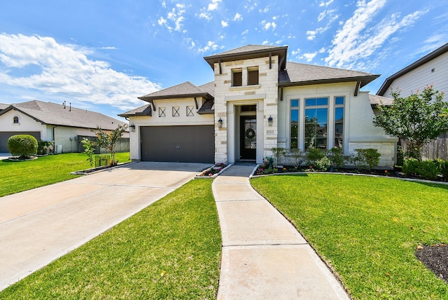 1907 Creekwood Cv, Missouri City, TX 77459 - view of front facade featuring stone siding, a garage, driveway, and a front lawn