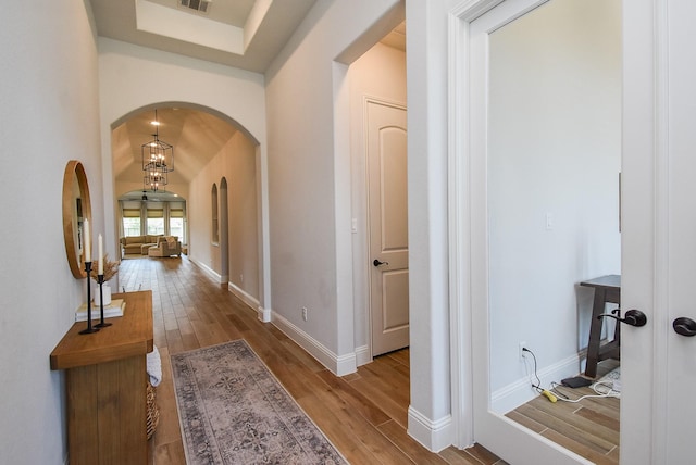 1907 Creekwood Cv, Missouri City, TX 77459 - corridor featuring arched walkways, wood finished floors, and baseboards