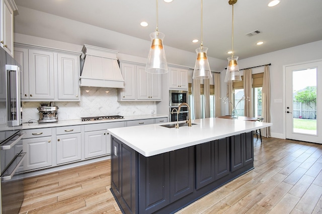 1907 Creekwood Cv, Missouri City, TX 77459 - kitchen with a sink, light wood finished floors, light countertops, backsplash, and recessed lighting