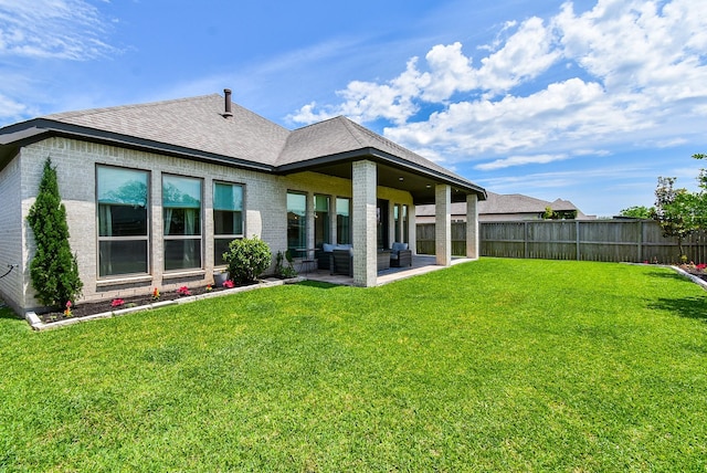 1907 Creekwood Cv, Missouri City, TX 77459 - back of property featuring roof with shingles, a patio area, and brick siding