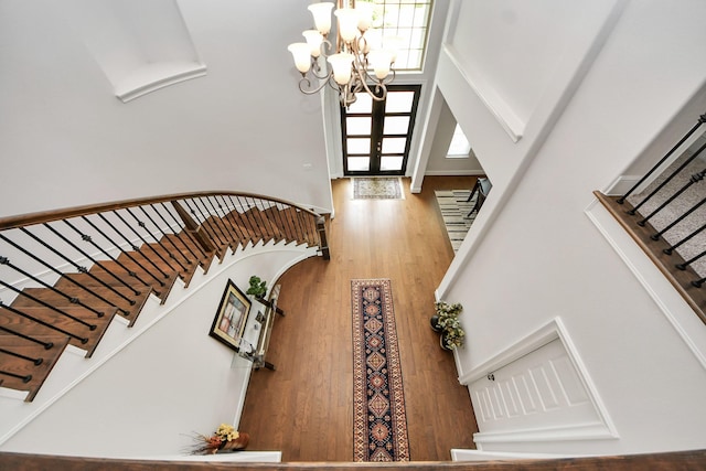 6510 Kangaroo Point Ln, Sugar Land, TX 77479 - staircase with a chandelier, wood finished floors, a towering ceiling, and french doors