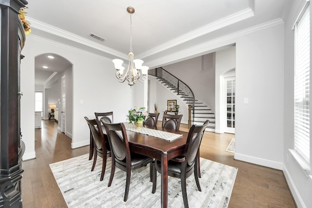 6510 Kangaroo Point Ln, Sugar Land, TX 77479 - dining area with stairway, arched walkways, a chandelier, ornamental molding, and wood finished floors