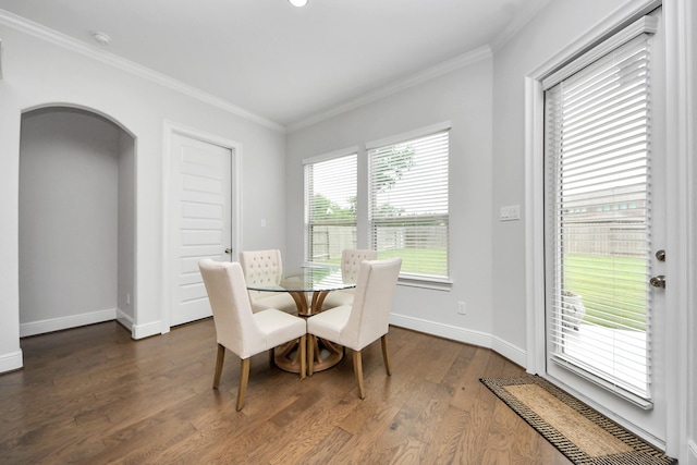 6510 Kangaroo Point Ln, Sugar Land, TX 77479 - dining space featuring crown molding, dark wood-type flooring, arched walkways, and baseboards