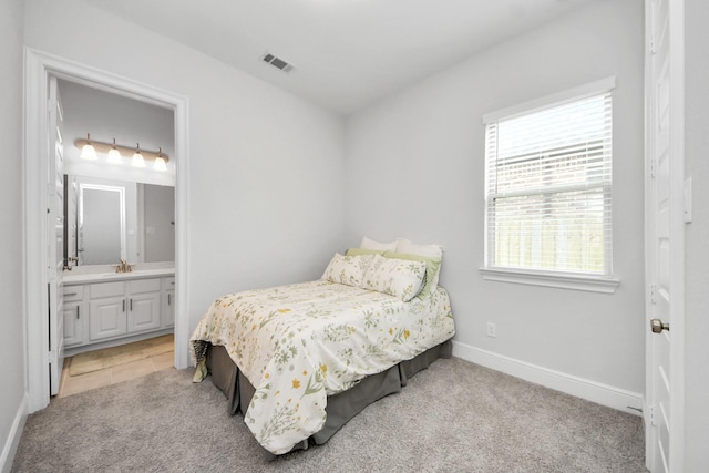 6510 Kangaroo Point Ln, Sugar Land, TX 77479 - bedroom with a sink, baseboards, ensuite bath, and light carpet