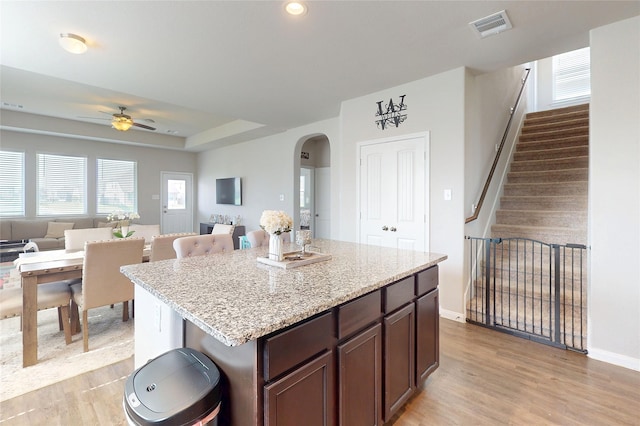 24803 Signorelli Way, Katy, TX 77493 - kitchen featuring arched walkways, light wood-type flooring, open floor plan, a ceiling fan, and recessed lighting