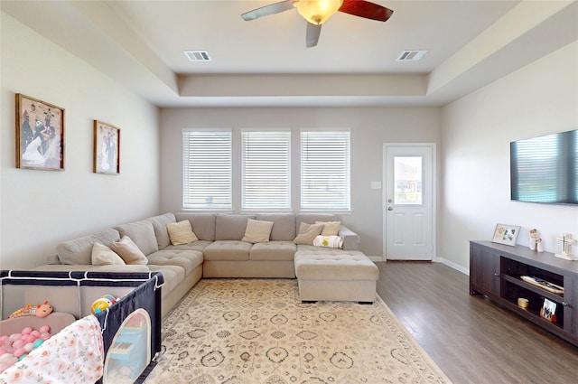 24803 Signorelli Way, Katy, TX 77493 - living area with wood finished floors, ceiling fan, a tray ceiling, and baseboards
