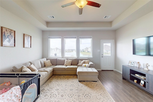 24803 Signorelli Way, Katy, TX 77493 - living area with plenty of natural light, wood finished floors, ceiling fan, and a raised ceiling
