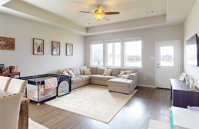 24803 Signorelli Way, Katy, TX 77493 - living area with wood finished floors, ceiling fan, a raised ceiling, and baseboards