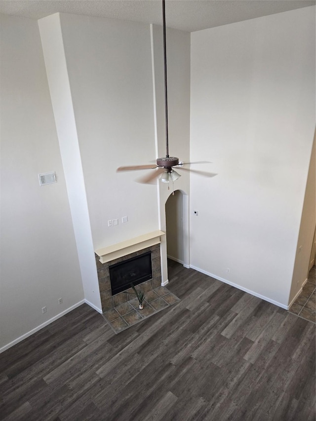 800 Mulligan Ct, Richmond, TX 77469 - detailed view of wood finished floors, a ceiling fan, a fireplace, baseboards, and arched walkways