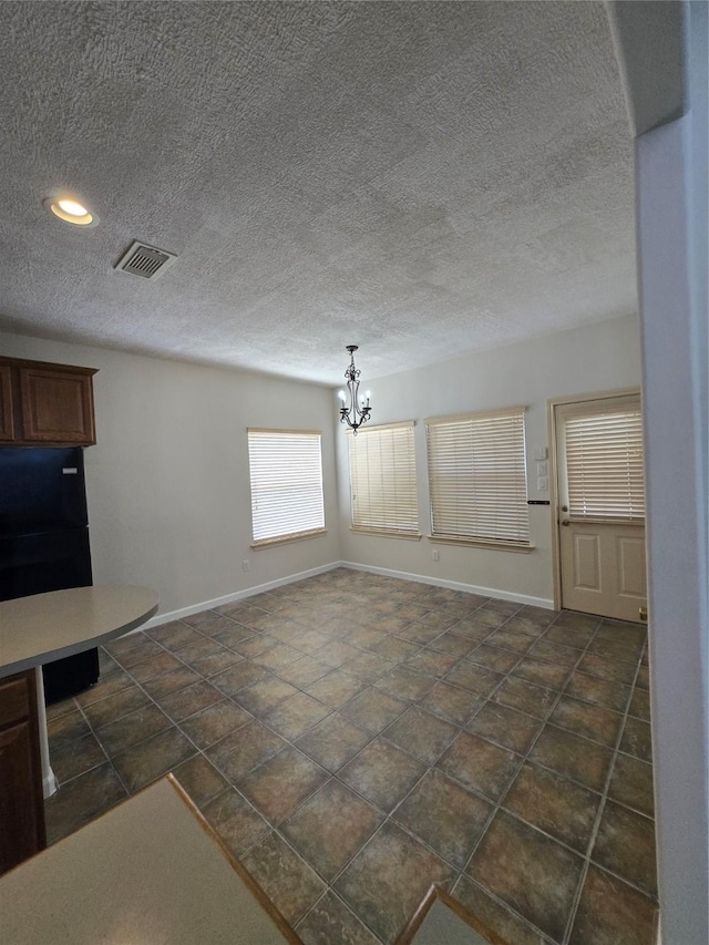 800 Mulligan Ct, Richmond, TX 77469 - unfurnished dining area with a chandelier, baseboards, a textured ceiling, and recessed lighting