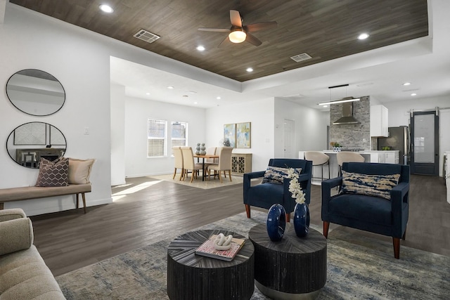304 Milby St, Houston, TX 77003 - living area featuring dark wood finished floors, wood ceiling, a ceiling fan, a raised ceiling, and baseboards