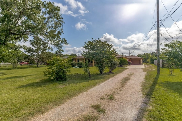 5718 Sheppard Rd, Baytown, TX 77521 - view of property hidden behind natural elements with driveway and a garage